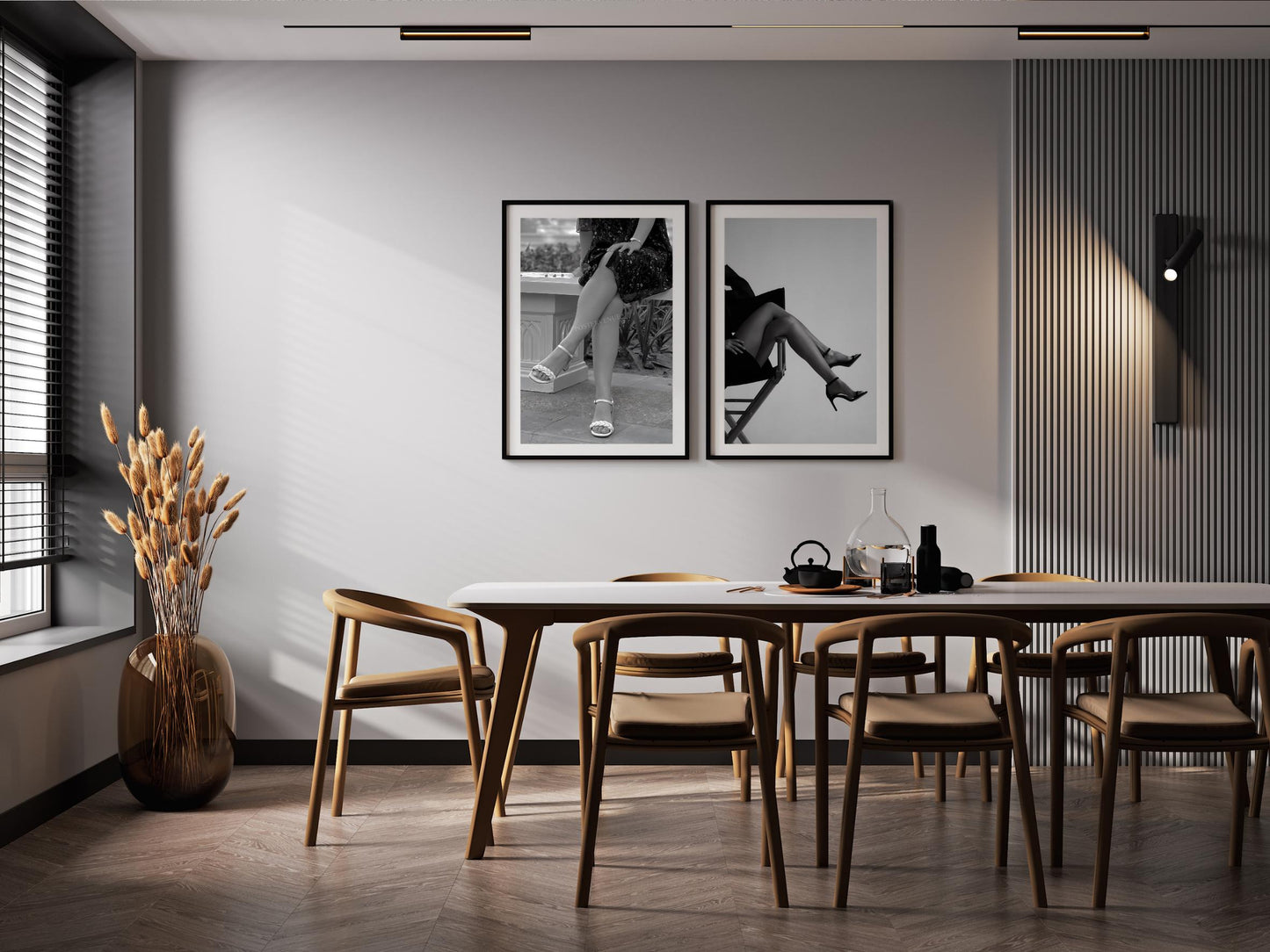 Dining room with wooden table and chairs, black and white photos on the wall, and a vase with dried plants.