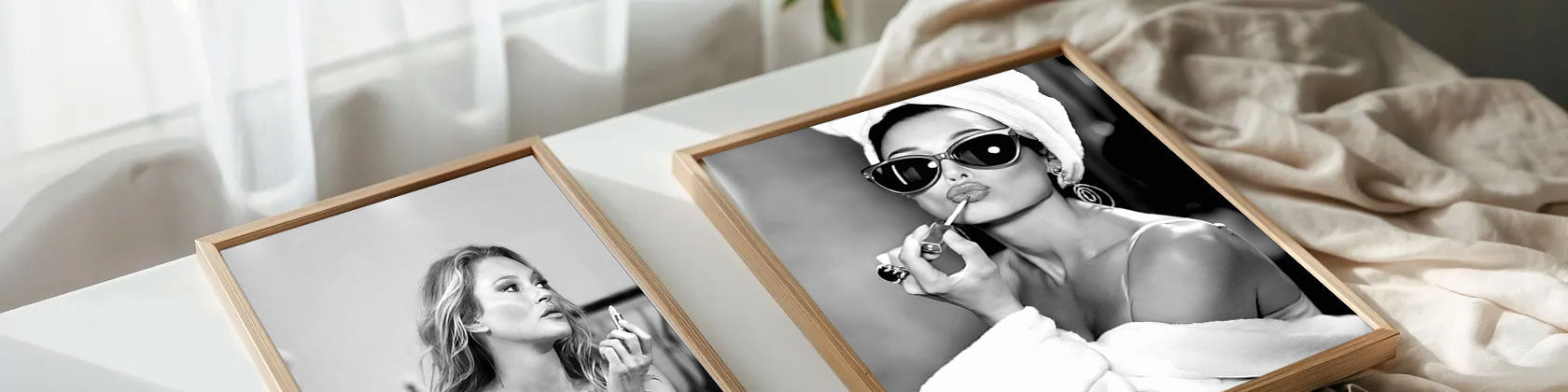 Two framed black and white photos of a woman on a table with a soft background