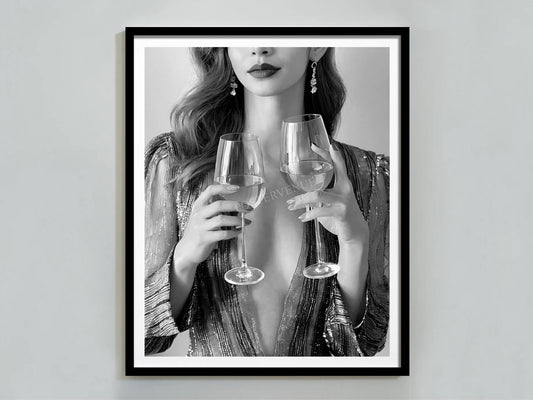 Framed artwork of a woman holding two wine glasses against a plain background