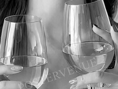 Two clear wine glasses on a reflective surface