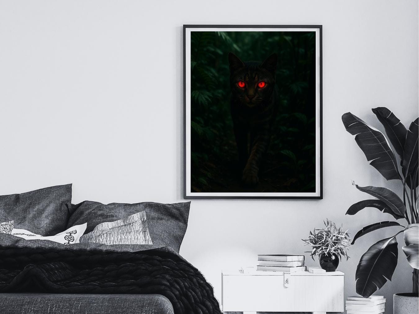 Framed artwork of a cat with red eyes on a wall above a bed.